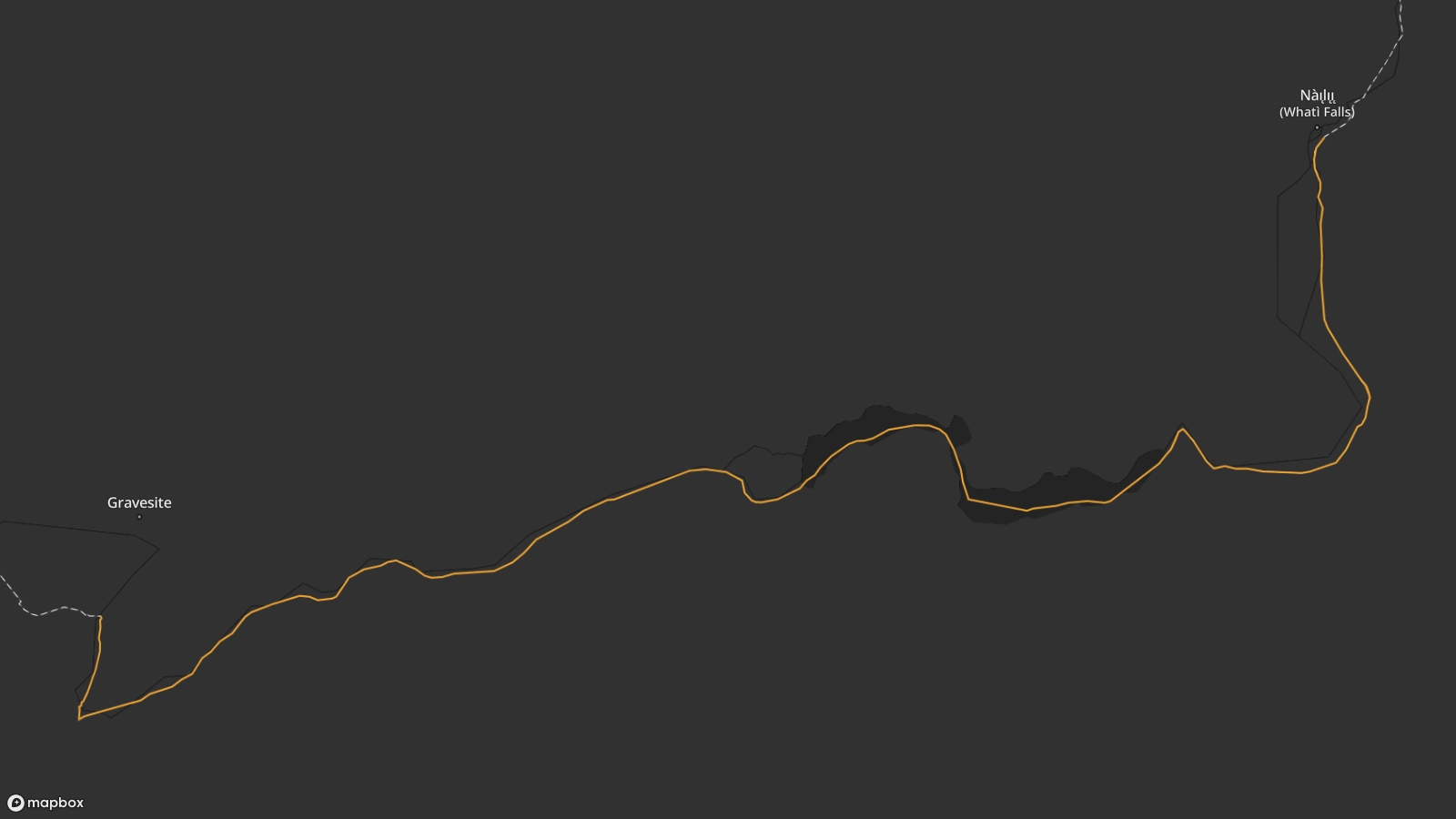 Map view of the Whatì Trail route from Nàı̨lı̨ı̨ (Whatì Falls) in the north east, to an unknown grave along the river in the south west. The river zigs and zags through the landscape.